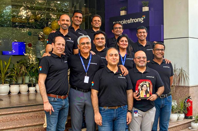 PeopleStrong Team standing infront of the office