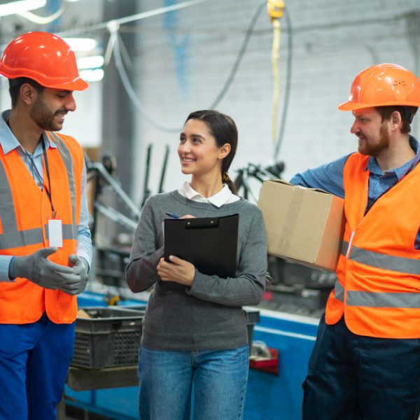 Employees interacting while working in a manufacturing plant