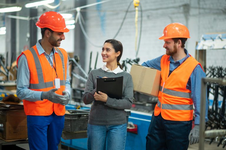 Employees interacting while working in a manufacturing plant